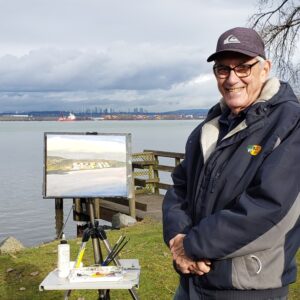 Artist standing by his painting outdoors